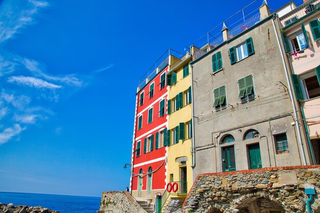 Low angle view of building by sea against blue sky