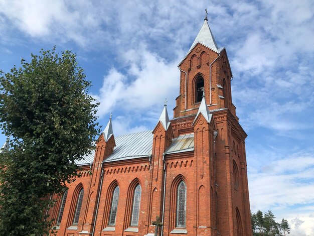 Low angle view of building and trees against sky