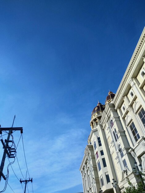 Low angle view of buildings against blue sky