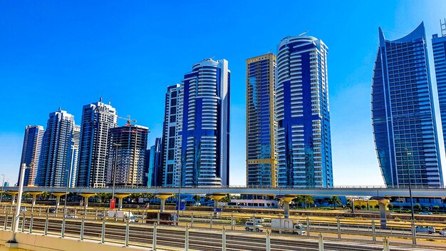 Low angle view of buildings against clear blue sky