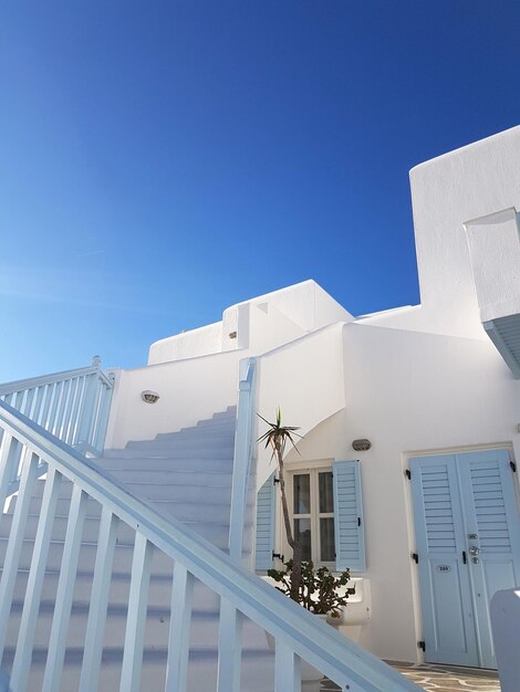 Low angle view of buildings against clear blue sky