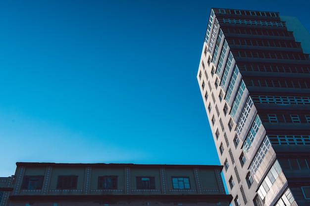 Low angle view of buildings against clear blue sky