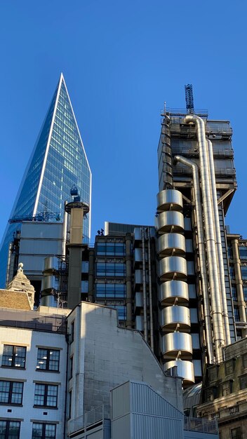 Low angle view of buildings against clear blue sky