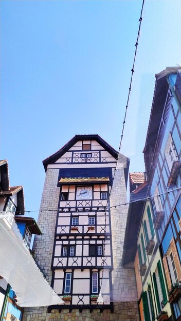 Low angle view of buildings against clear blue sky