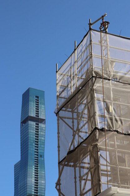 Low angle view of buildings against clear blue sky