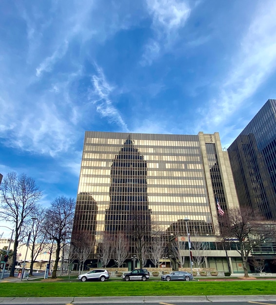 Low angle view of buildings against cloudy sky