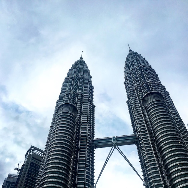 Low angle view of buildings against cloudy sky