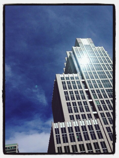 Low angle view of buildings against cloudy sky