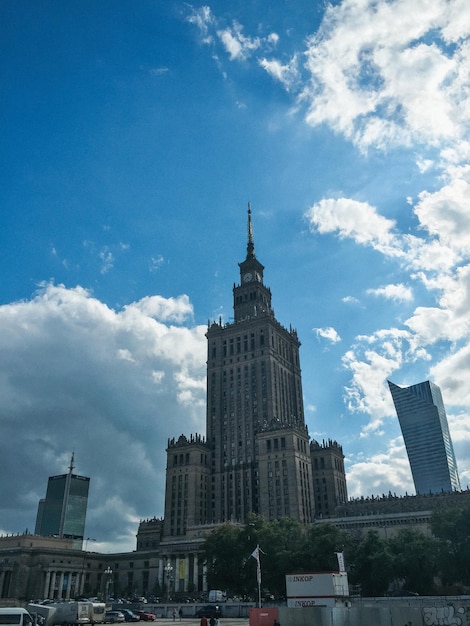 Low angle view of buildings against cloudy sky