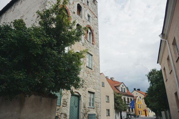 Low angle view of buildings against cloudy sky