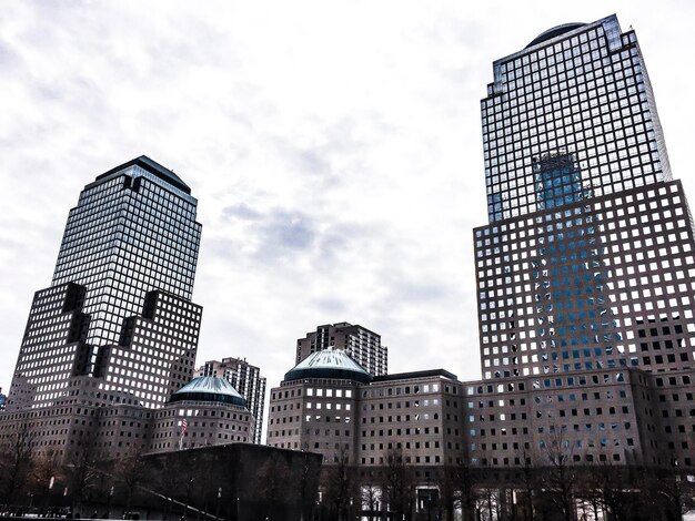 Low angle view of buildings against cloudy sky