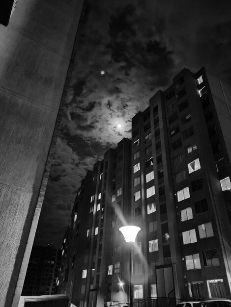 Low angle view of buildings against sky at night