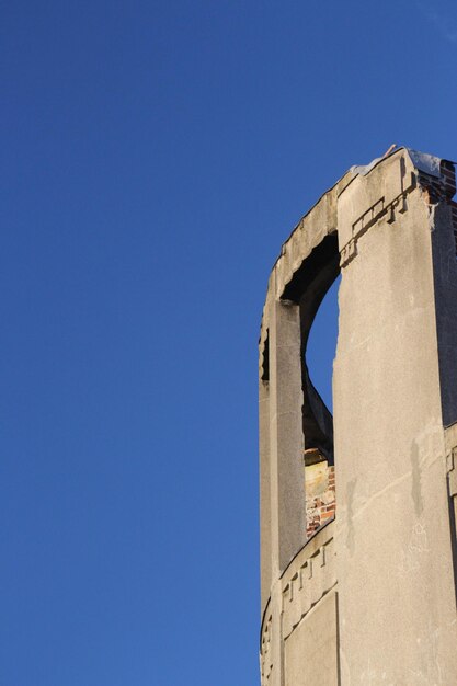 Low angle view of built structure against clear blue sky