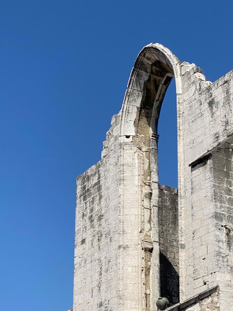 Low angle view of built structure against clear blue sky