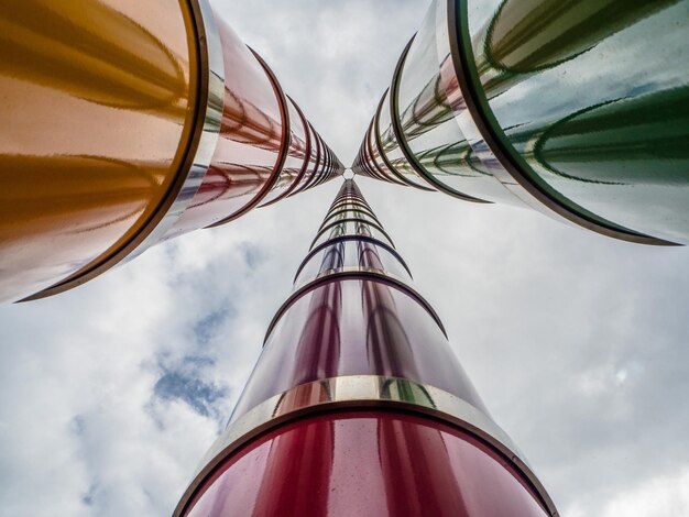 Low angle view of built structures against cloudy sky