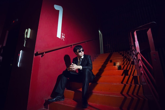 Low angle view of businessman sitting on red steps