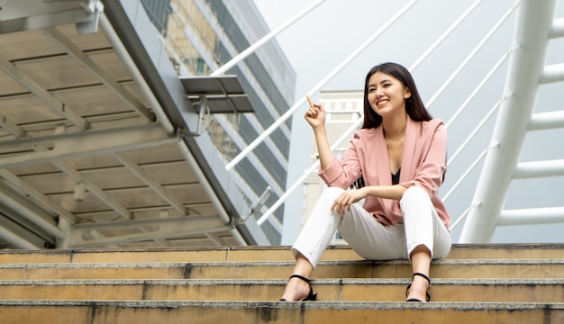 Low Angle View Of Businesswoman Pointing 