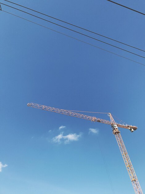 Low angle view of cables against blue sky