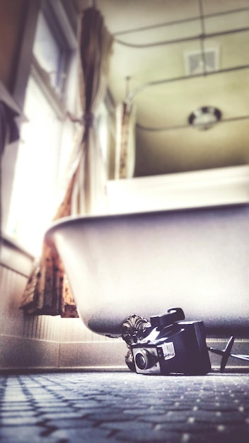 Low angle view of camera by bathtub at home