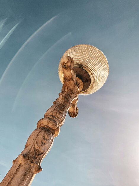 Low angle view of carving on wood against sky