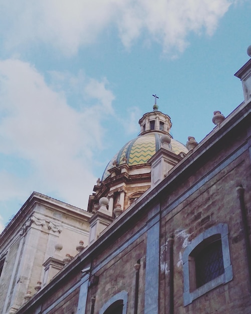 Low angle view of cathedral against cloudy sky