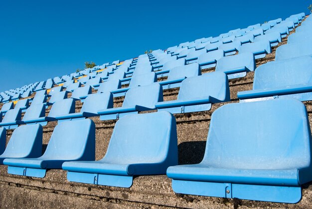 Low angle view of chairs against clear blue sky