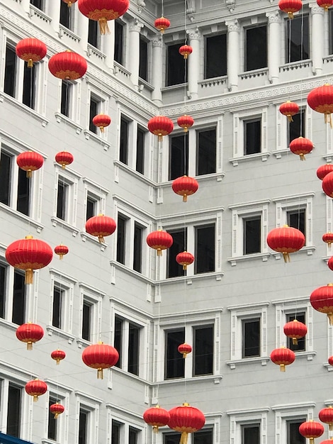 Low angle view of chinese lanterns hanging against white building