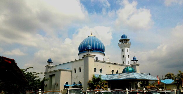 Low angle view of church against cloudy sky