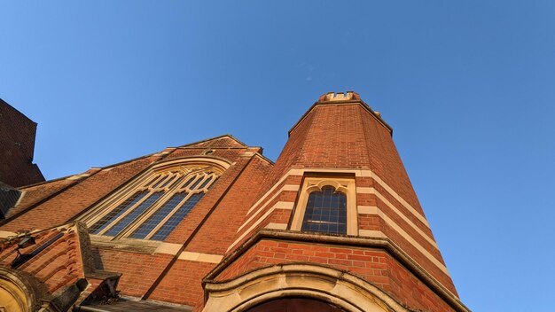 Low angle view of church building against clear blue sky