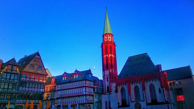 Low angle view of clock tower against blue sky