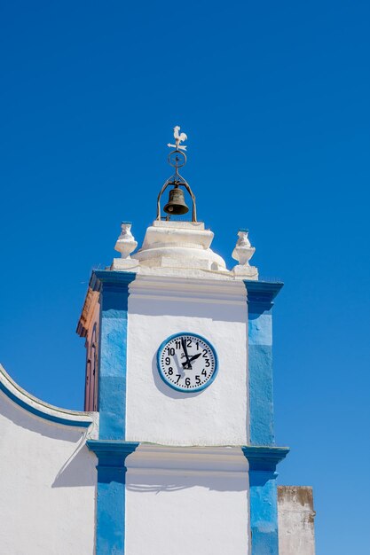 Low angle view of clock tower against clear blue sky