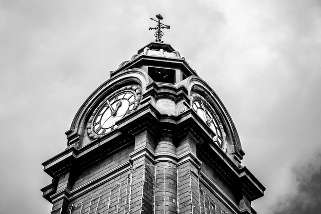 Low angle view of clock tower against sky