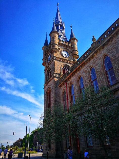 Low angle view of clock tower against sky