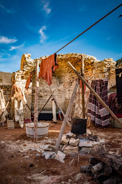 Low angle view of clothes drying on abandoned building against sky