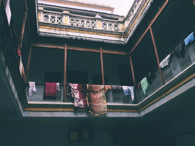 Photo low angle view of clothes hanging on building