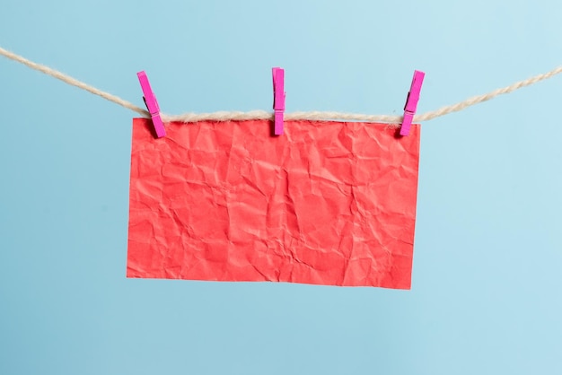 Photo low angle view of clothes hanging on rope against blue background