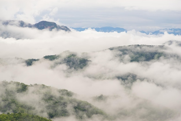 Low angle view of clouds covering mountains against sky