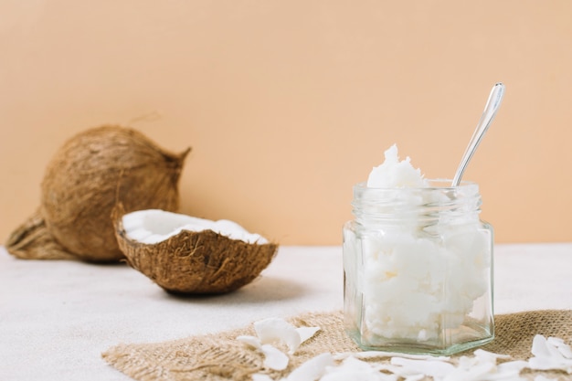 Photo low angle view coconut oil in jar with nut