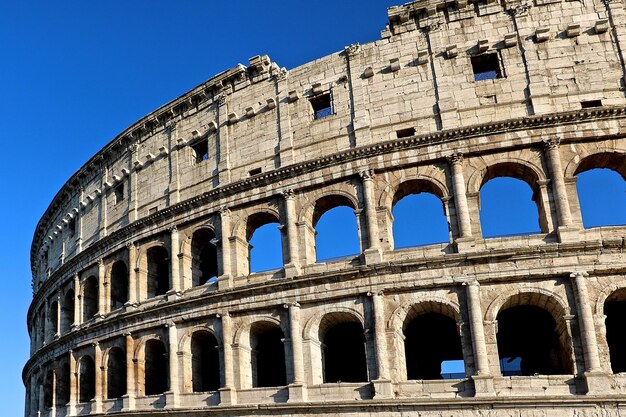 Low angle view of coliseum against clear sky