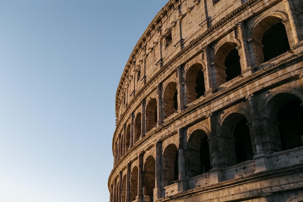 Low angle view of coliseum against clear sky
