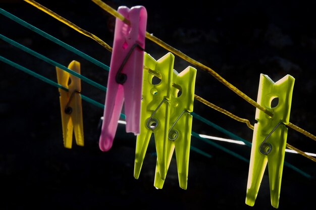 Photo low angle view of colorful clothespins hanging on clothesline at night