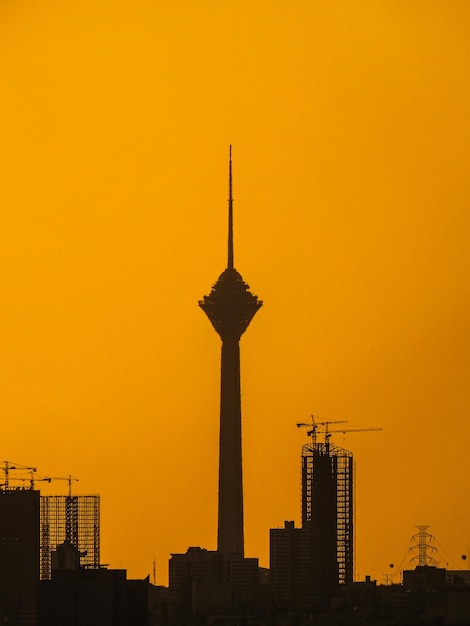 Low angle view of communication tower against sky during sunset
