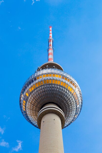 Low angle view of communications tower against blue sky