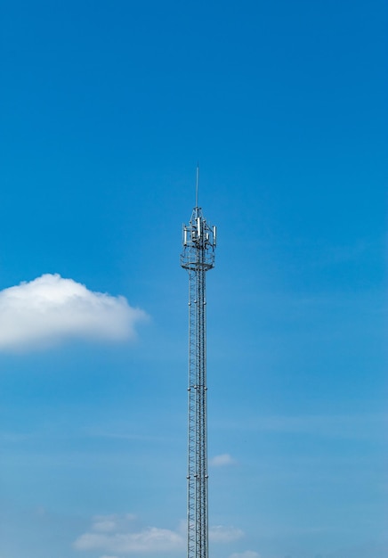 Low angle view of communications tower against blue sky