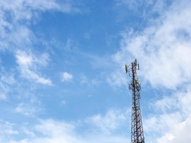 Low angle view of communications tower against blue sky