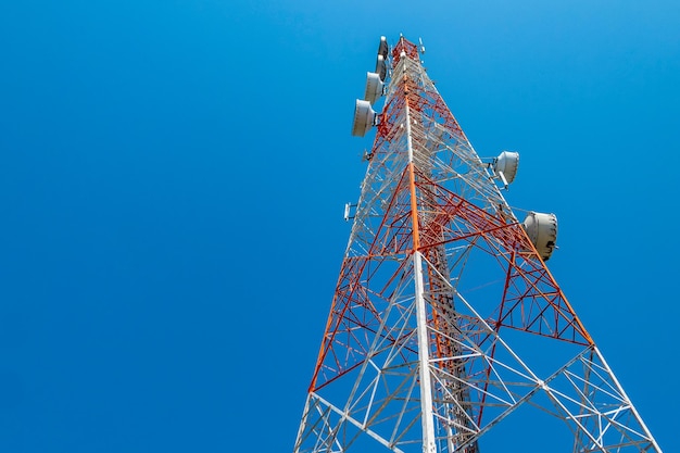 Low angle view of communications tower against clear blue sky