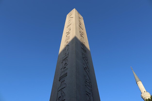 Low angle view of communications tower against clear blue sky