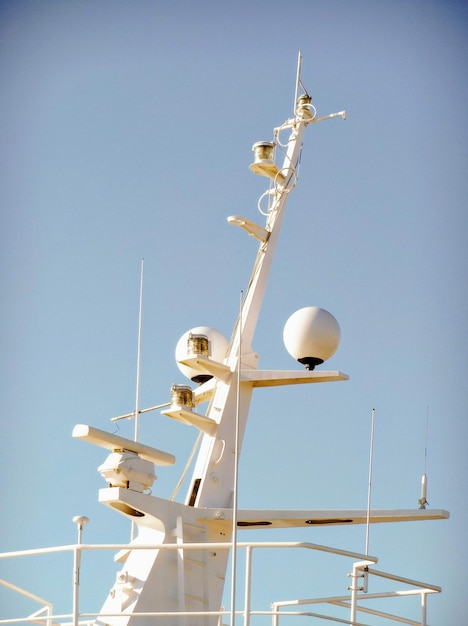 Low angle view of communications tower against clear blue sky