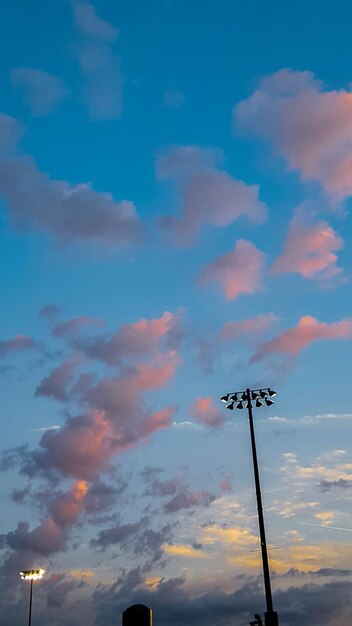 Low angle view of communications tower against sky during sunset