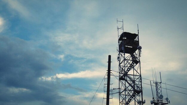 Low angle view of communications tower against sky